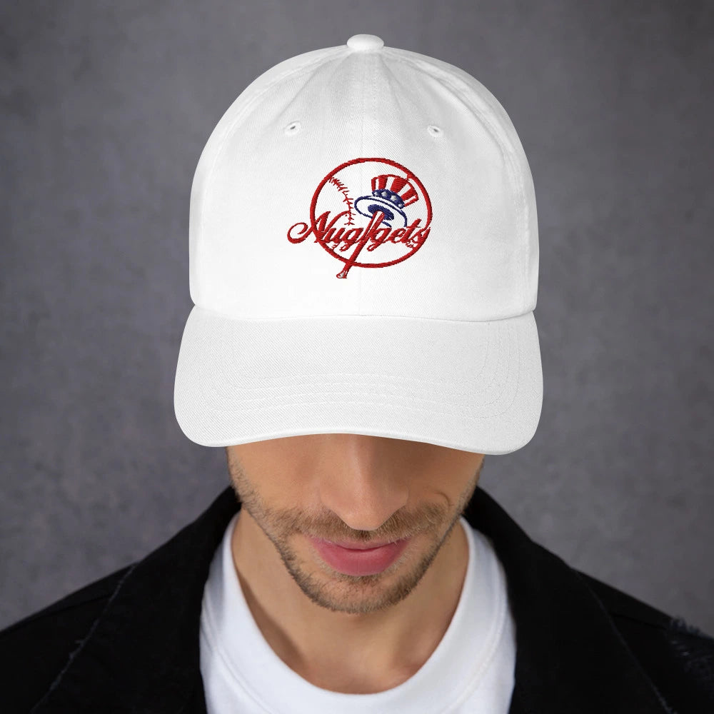 Close-up front view of man wearing white New Your Nuggets hat with red embroidered baseball-inspired logo