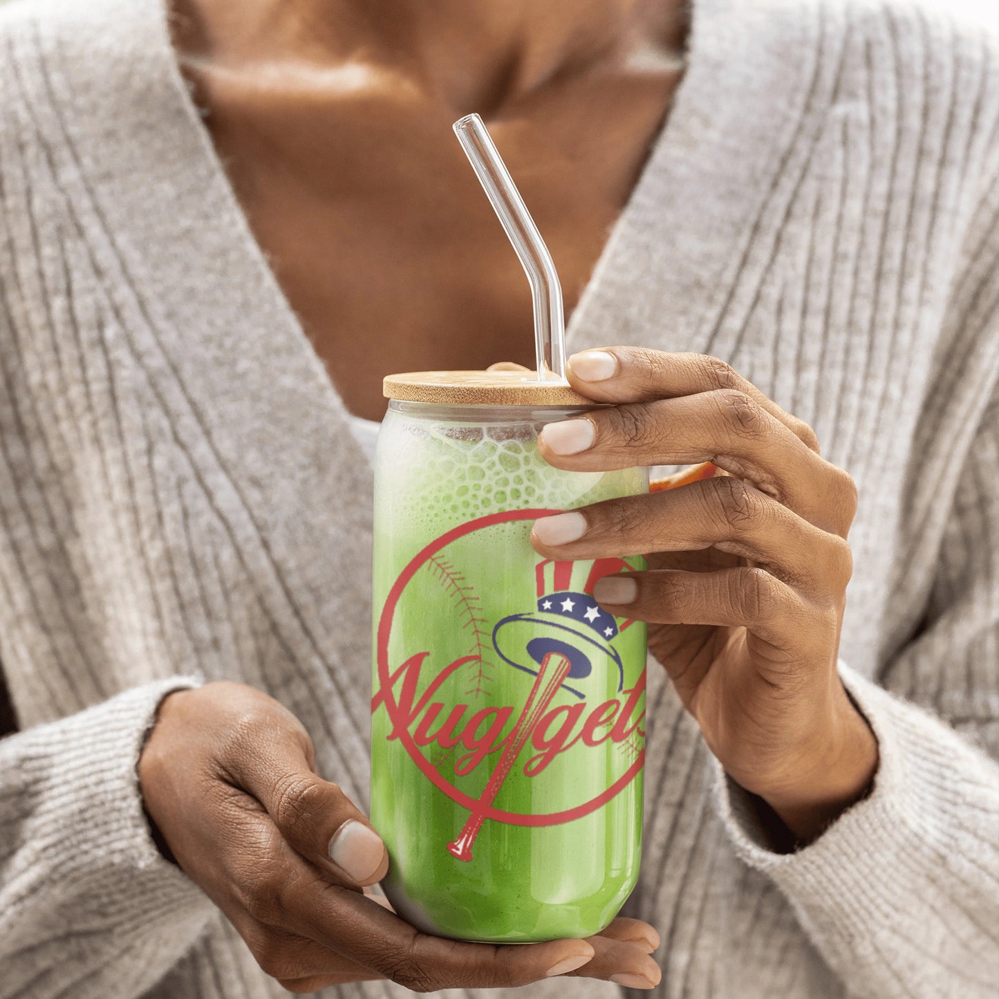 Woman holding the glass filled with a green smoothie