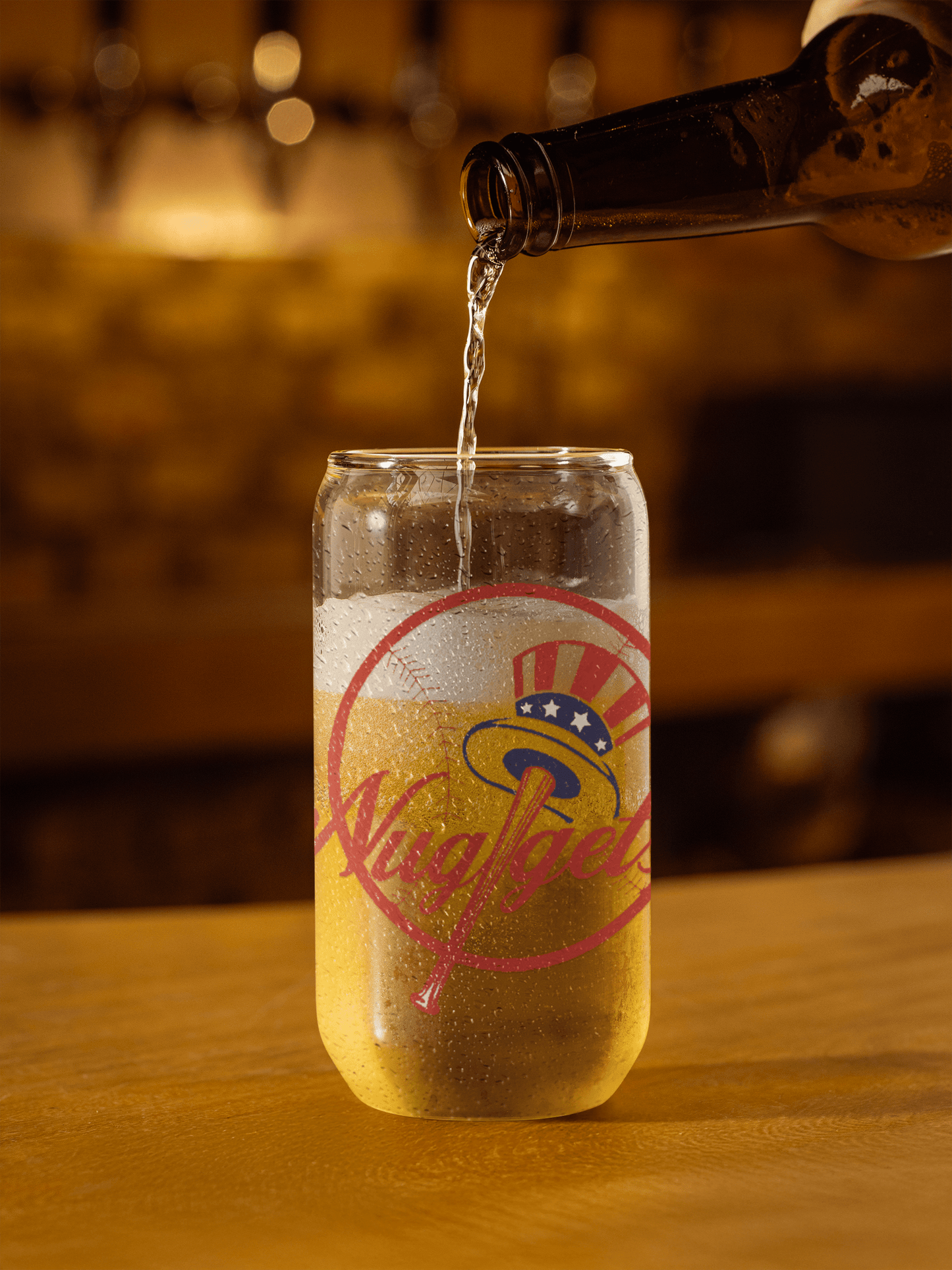 Pouring drink into the can-shaped glass on a wooden table