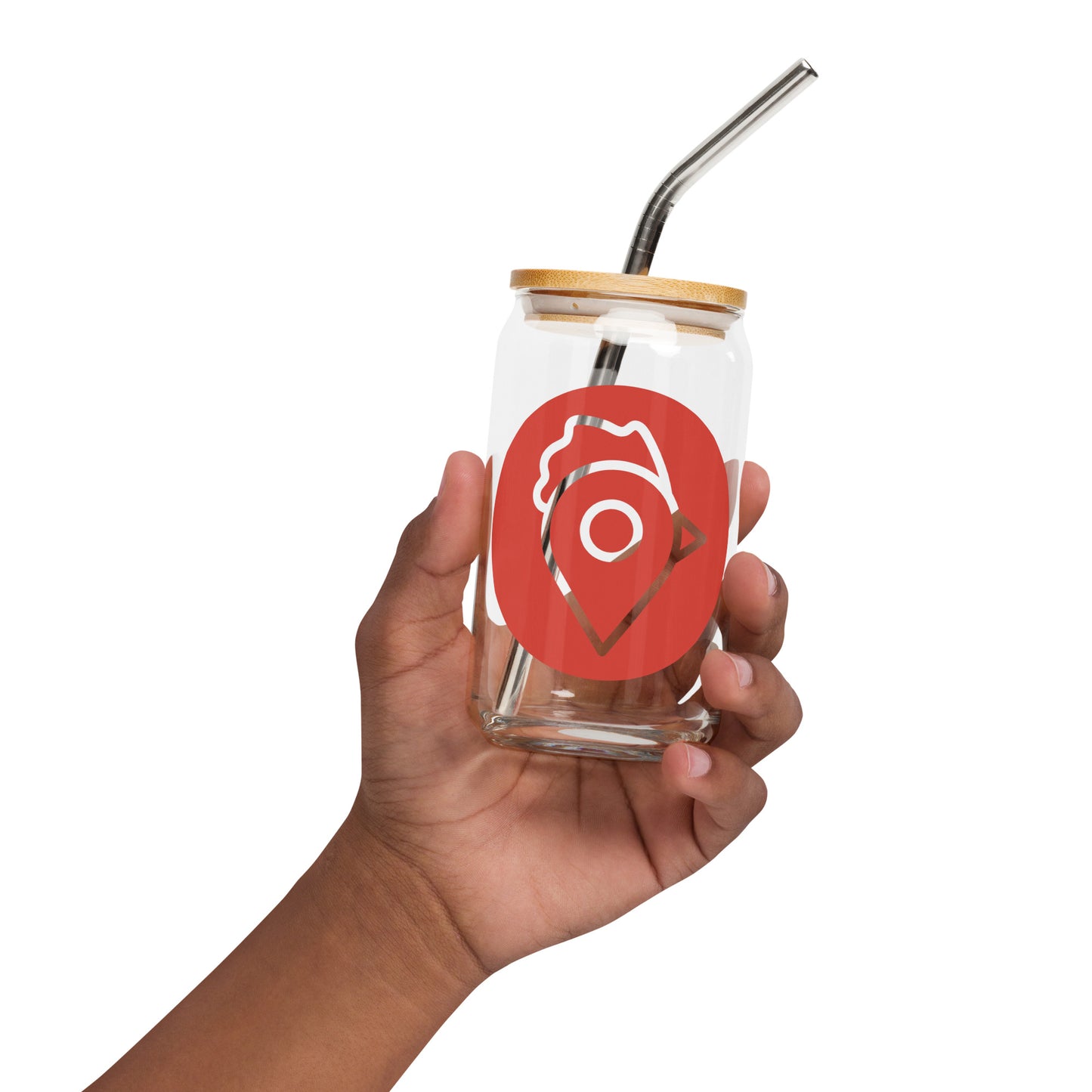 A hand holding The Nugget Spot can-shaped glass with a stainless steel straw and bamboo lid.
