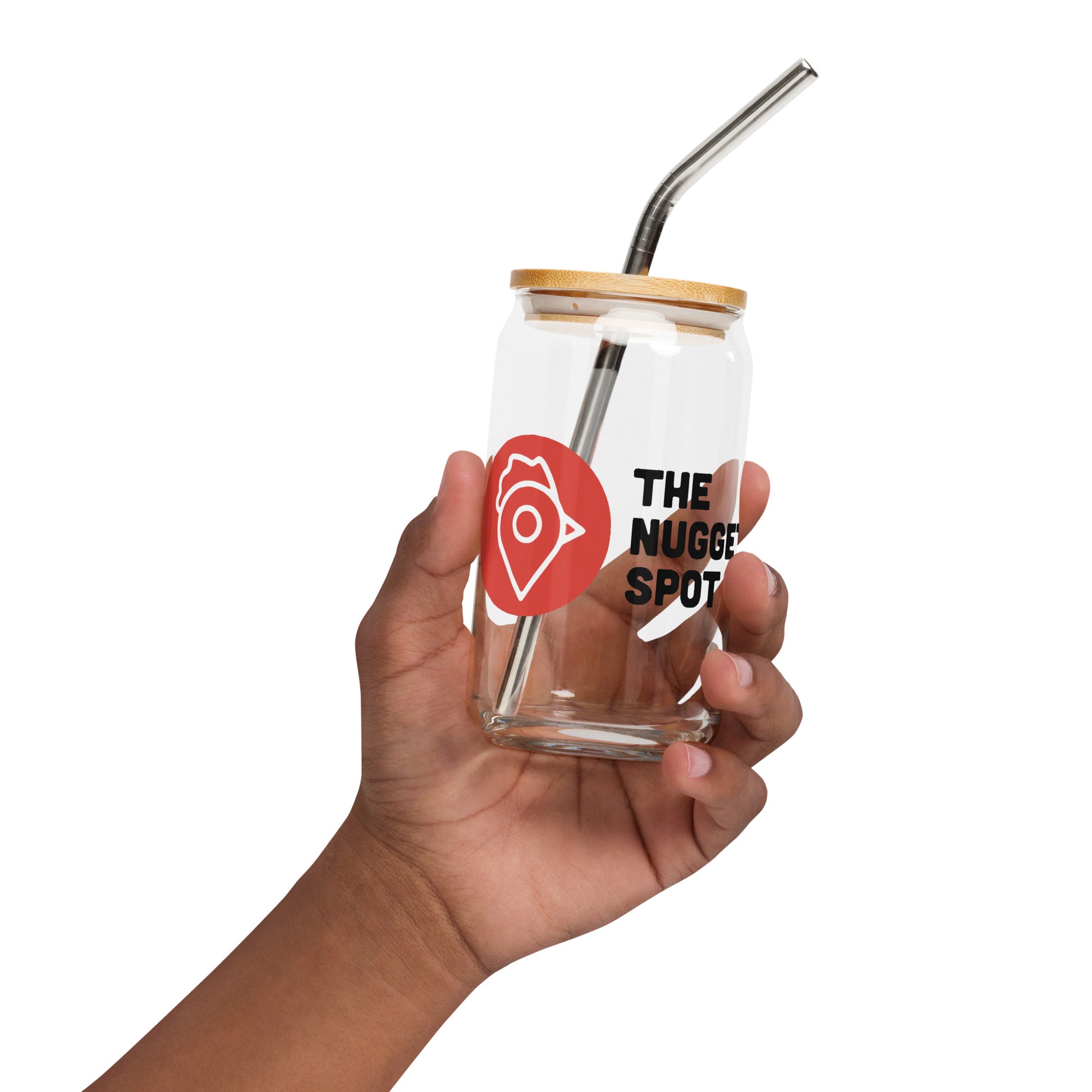 Hand holding The Nugget Spot 16oz can glass with bamboo lid and metal straw
