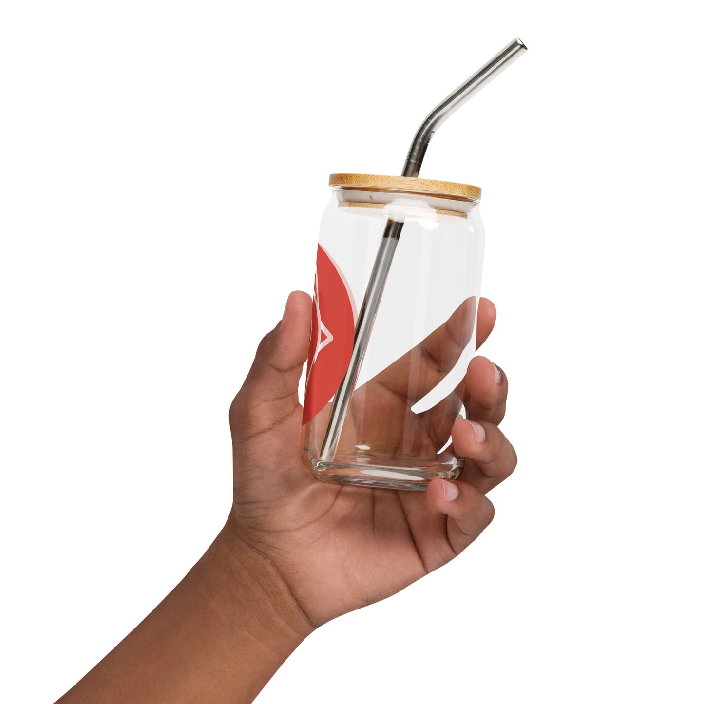 A side view of the same hand holding the glass and straw at an angle.
