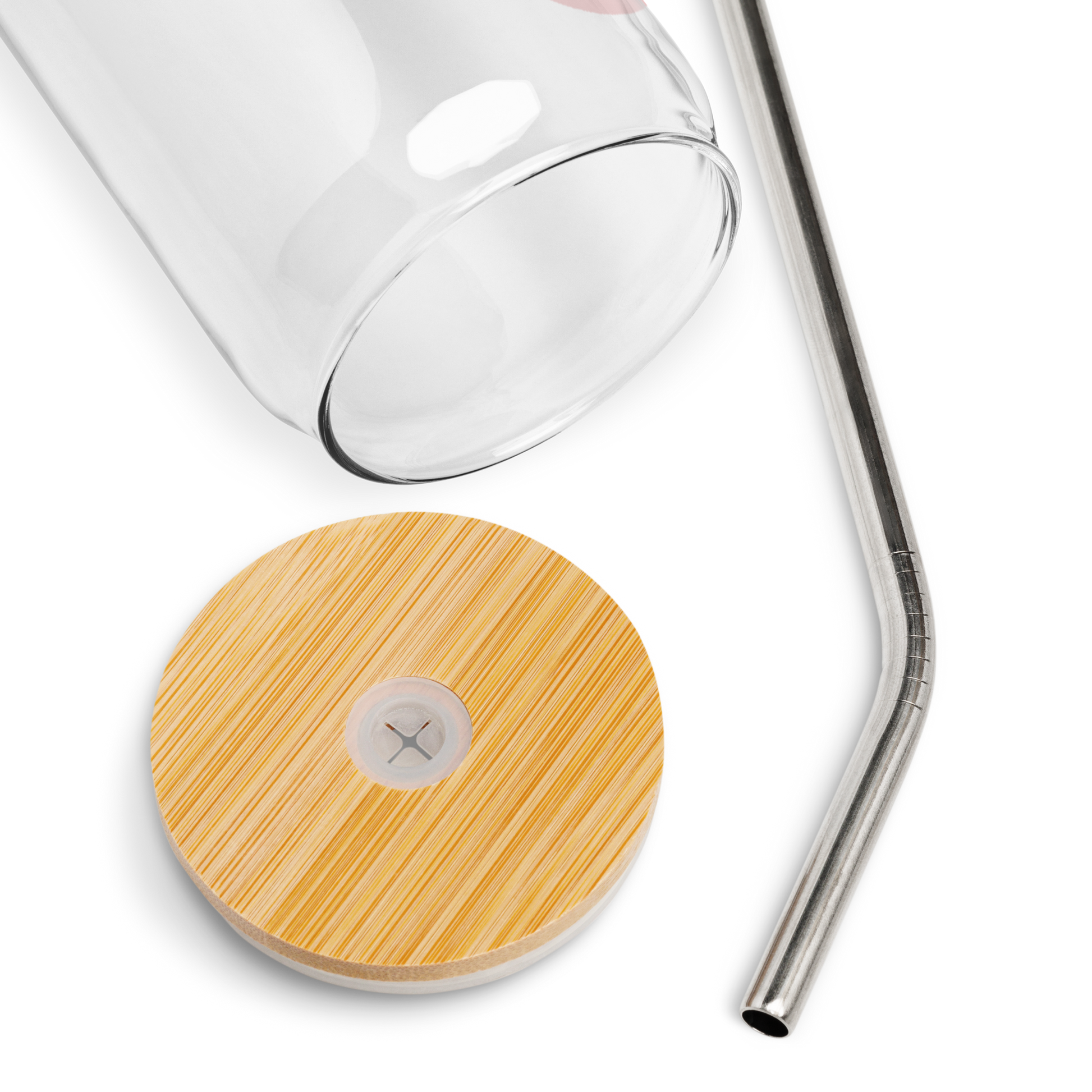 Close-up of glass, bamboo lid, and straw laid out on a transparent background