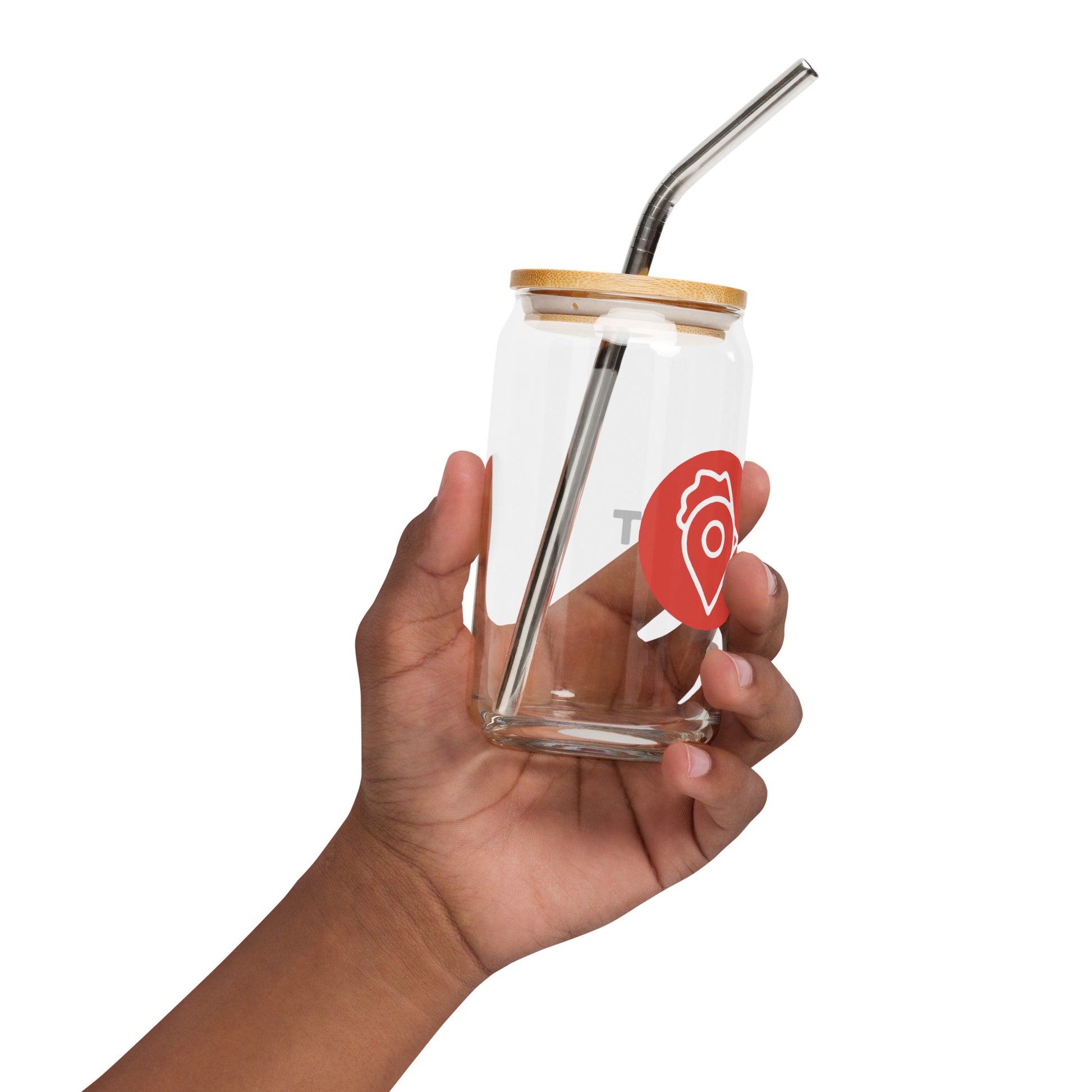 Hand holding The Nugget Spot 16oz can glass with bamboo lid and metal straw
