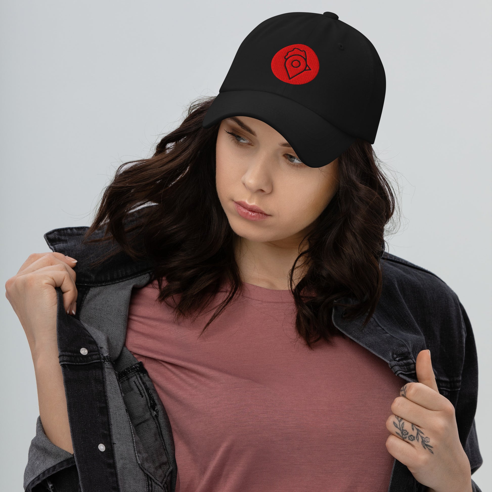 Model in black denim jacket wearing black Nugget Spot Signature Dad Hat.