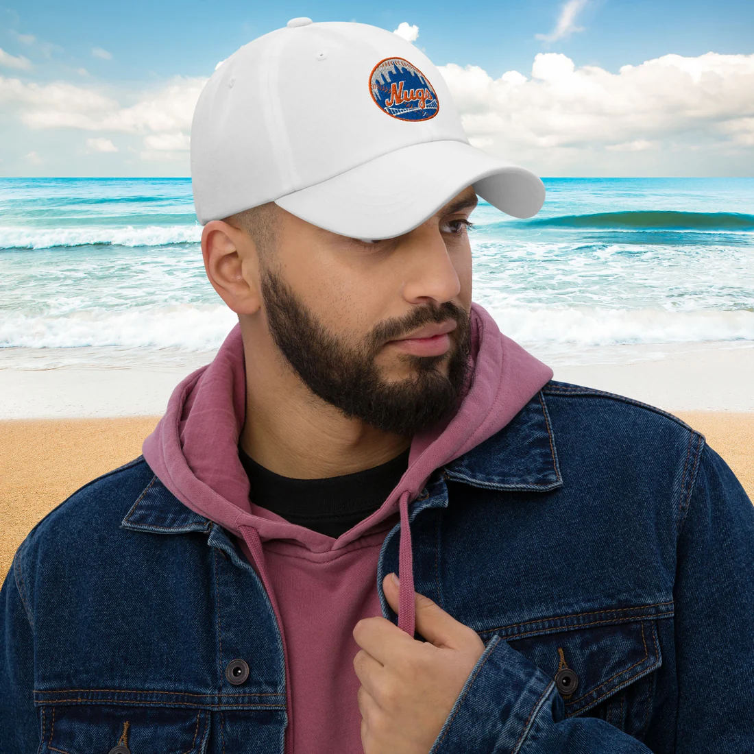 Man wearing New York Nugs Dad Hat and denim jacket by the beach
