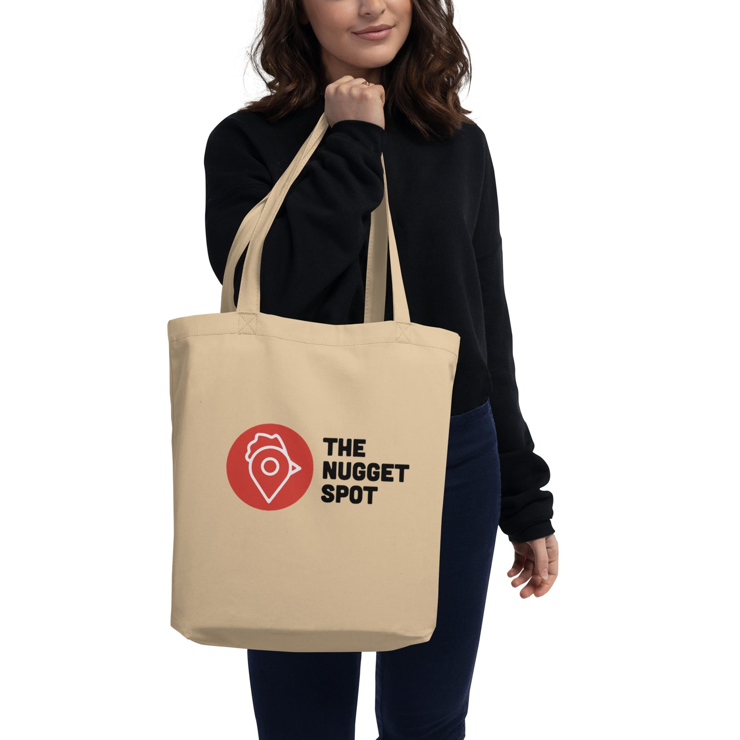 Person holding The Nugget Spot Eco-Friendly Tote Bag over shoulder
