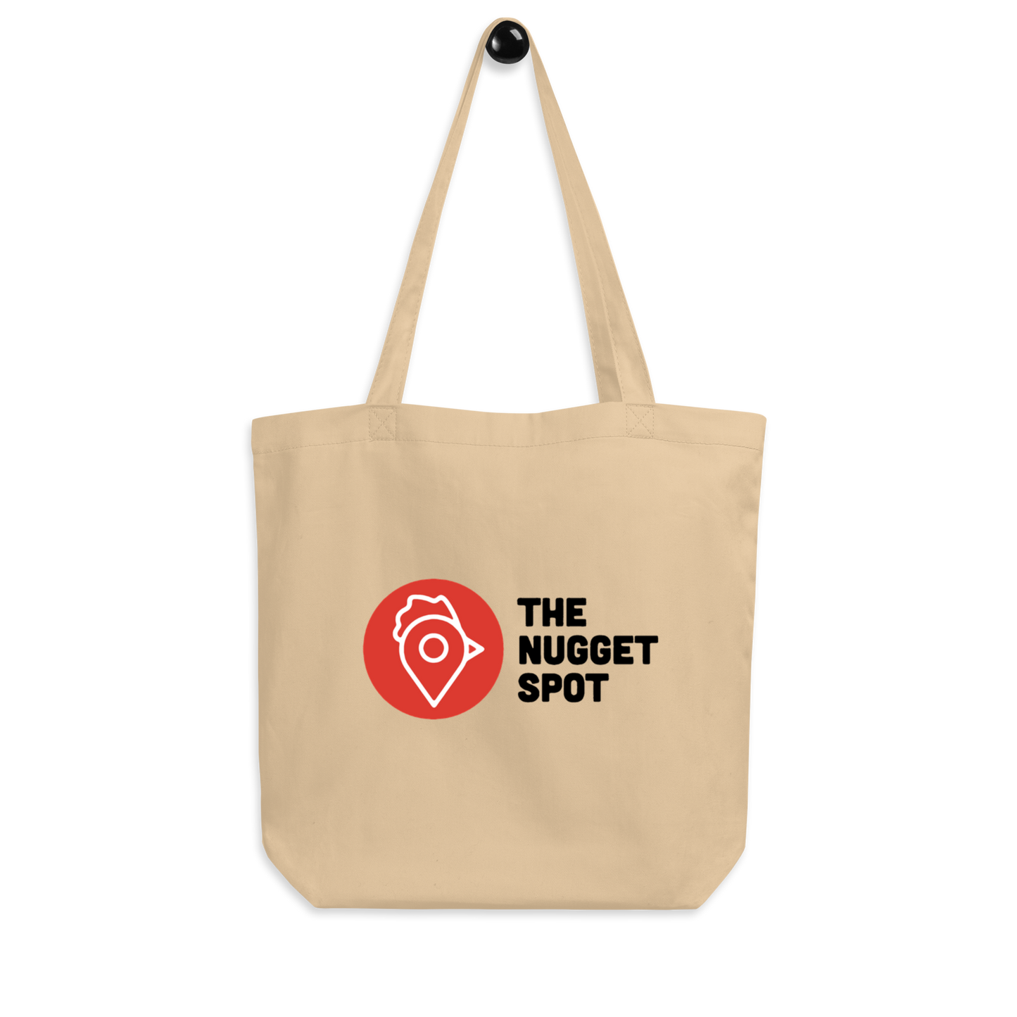 Tote bag hanging on hook showing The Nugget Spot logo

