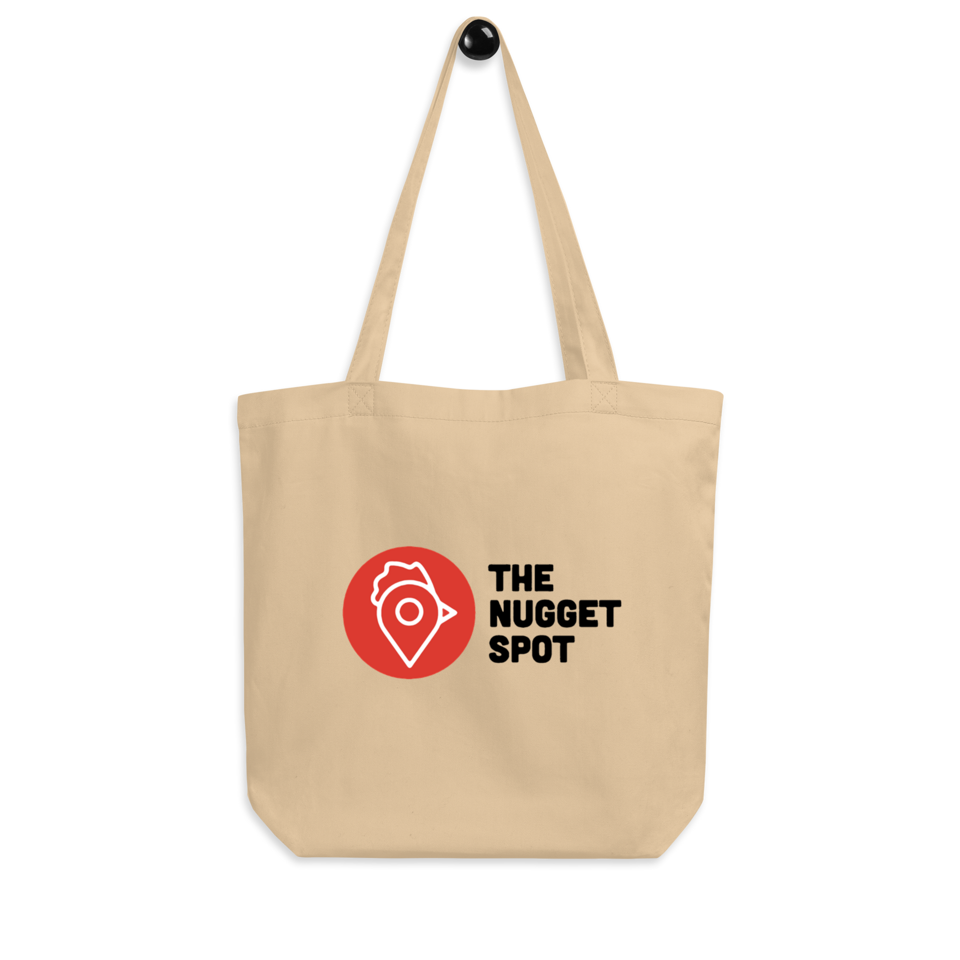 Tote bag hanging on hook showing The Nugget Spot logo
