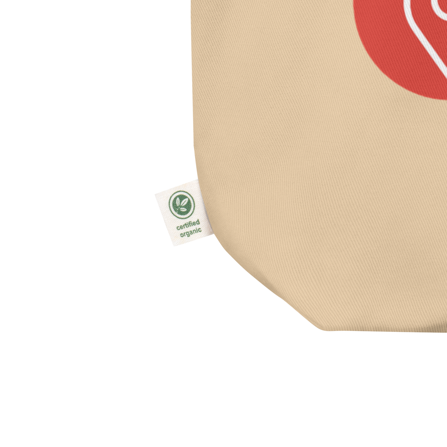 Close-up of organic cotton certification tag on tote bag corner
