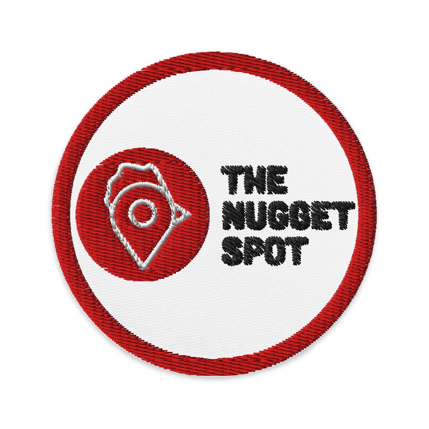 Close-up of The Nugget Spot 3-inch iron or sew-on embroidered patch – detailed red and black logo on white twill backing.