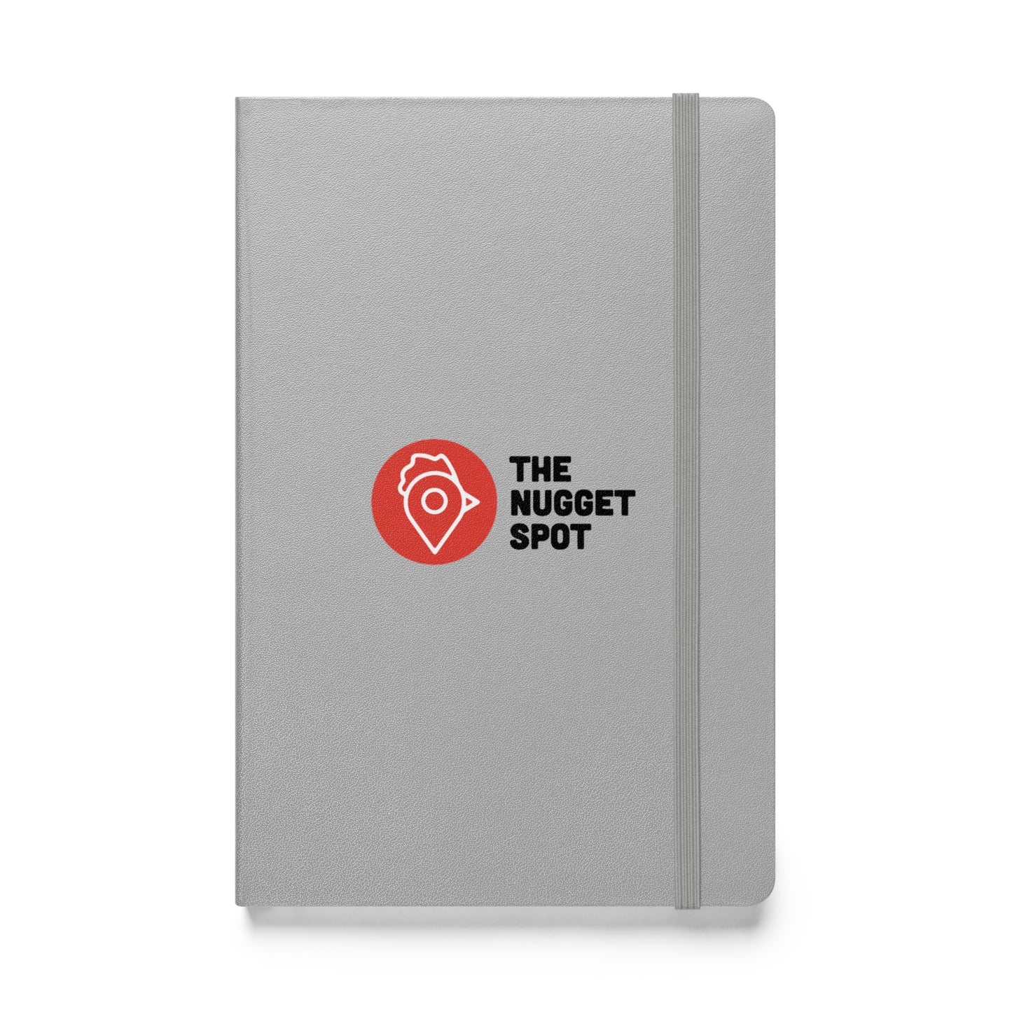 Close-up front view of The Nugget Spot silver hardcover notebook with elastic closure.