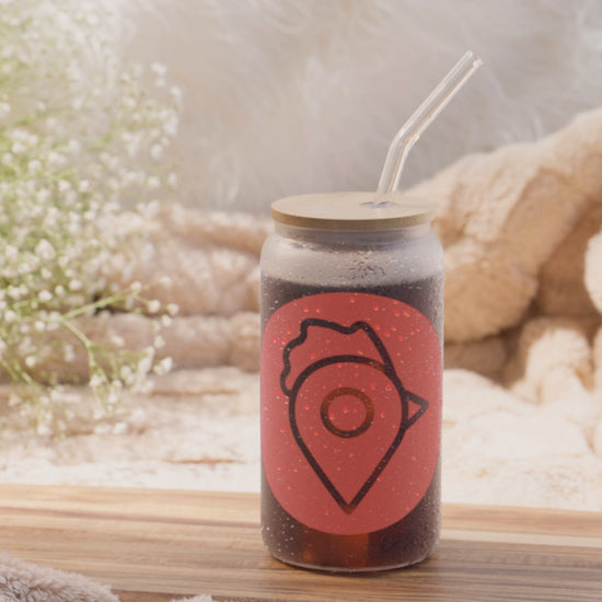 view of The Nugget Spot Signature 16oz can-shaped glass showcasing its design, bamboo lid, and straw in motion