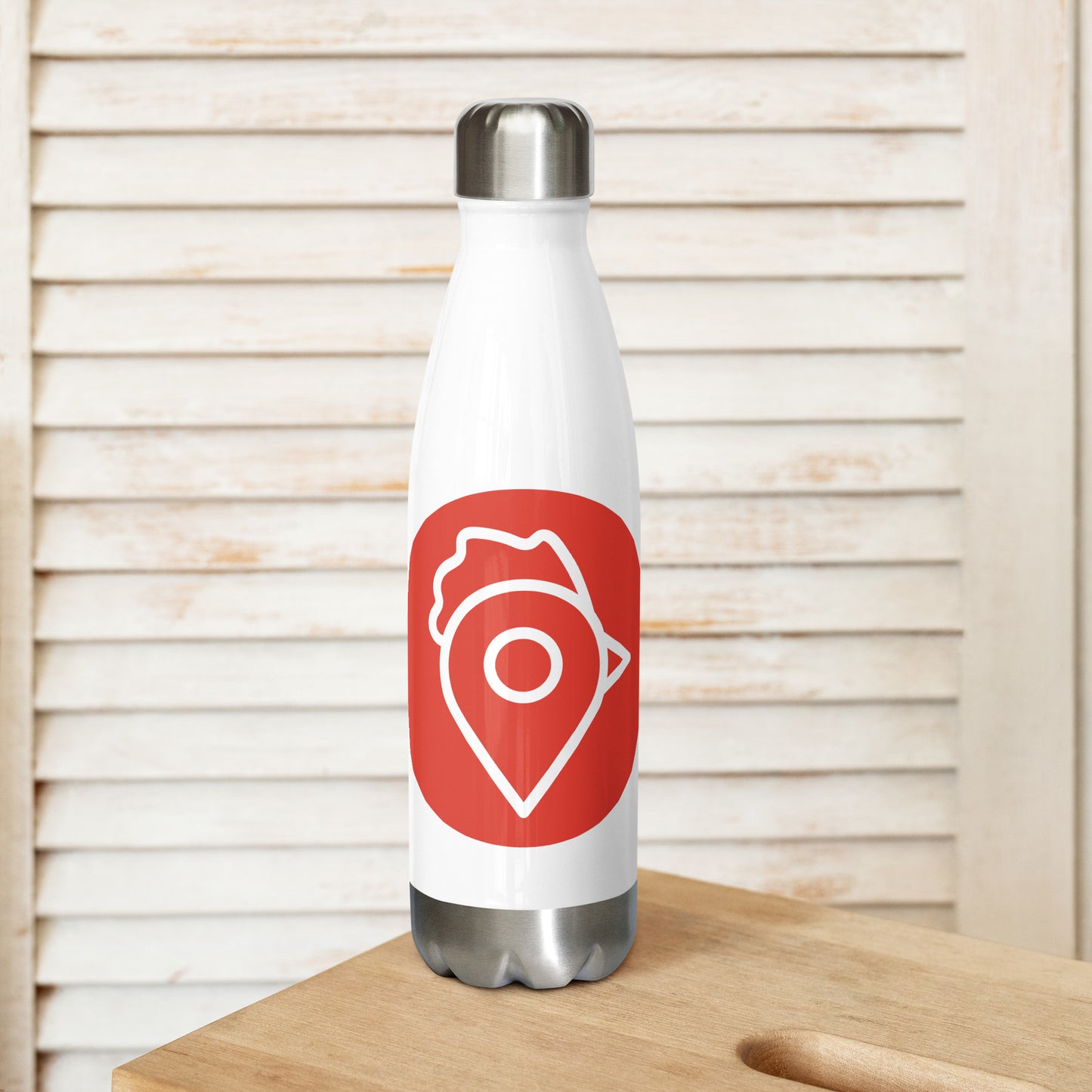 The Nugget Spot Signature black stainless steel water bottle standing on a wooden table with neutral background.