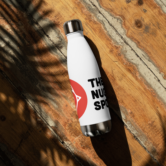 White The Nugget Spot 17oz Stainless Steel Water Bottle on a wooden surface with shadow details.